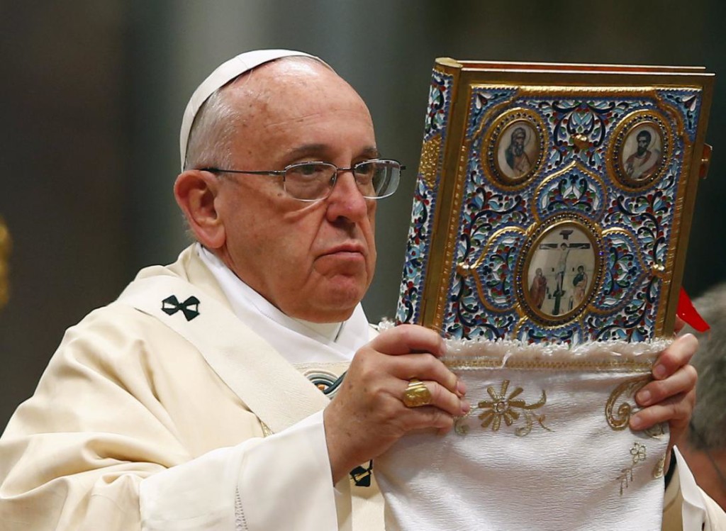 Pope Francis blesses the missal as he leads a mass on the 100th anniversary of the Armenian mass killings, in St. Peter's Basilica at the Vatican